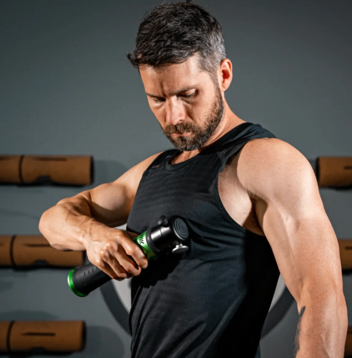 Athlete using a Rapid Release massage device on his torso